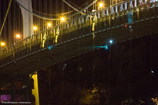 Activists hang under the St. Johns Bridge in Portland, Oregon, In an attempt to block the Shell leased icebreaker, MSV Fennica July 29, 2015. The climbers are currently preventing the ship from passing underneath the bridge on its way to meet Shells drilling fleet. The climbers have enough supplies to last for several days. According to the latest federal permit, the Fennica must be at Shells drill site before Shell can reapply for federal approval to drill deep enough for oil in the Chukchi Sea.