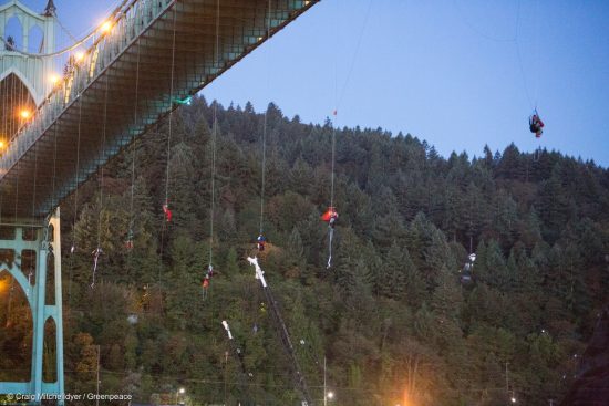 Activists hang under the St. Johns Bridge in Portland, Oregon, In an attempt to block the Shell leased icebreaker, MSV Fennica July 29, 2015. The climbers are currently preventing the ship from passing underneath the bridge on its way to meet Shells drilling fleet. The climbers have enough supplies to last for several days. According to the latest federal permit, the Fennica must be at Shells drill site before Shell can reapply for federal approval to drill deep enough for oil in the Chukchi Sea.