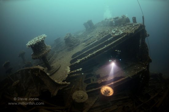 The 32,234 ton White Star Liner Justicia was used as a troopship in WW1. This image shows the vast foredeck, with capstans pushed up through the collapsing deck.