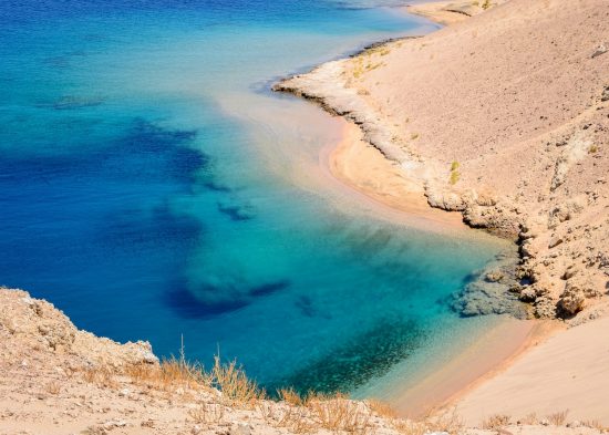 In the picture a beautiful turquoise lagoon with rocky beaches located in Egypt in the Red Sea