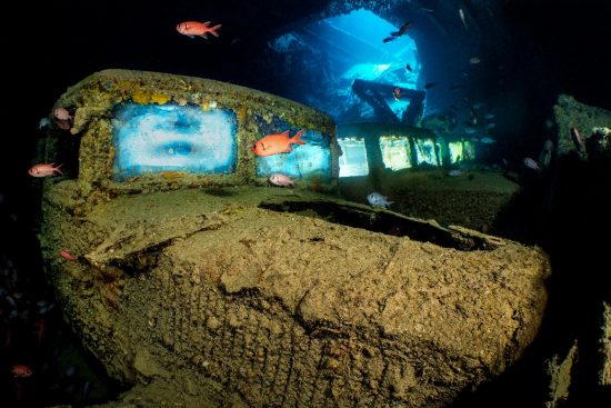 Three Fordson WOT 3 trucks (illuminated by off-camera strobes), srrounded by Red Sea soldierfish (Myripristis murdjan) on the lower level of Hold 2 of the wreck of the SS Thistlegorm. Sha'ab Ali, Red Sea. Sinai, Egypt.